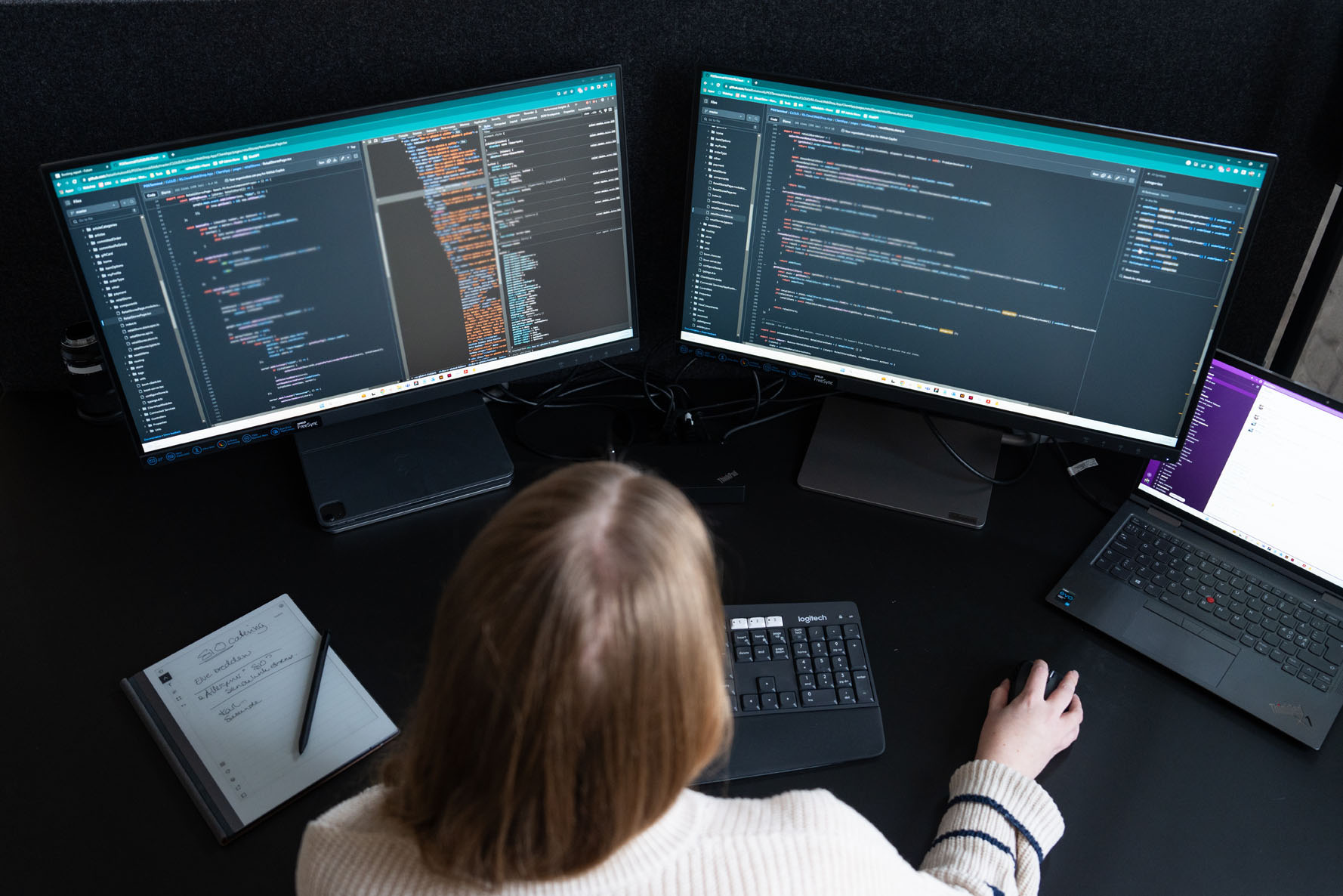 A Munu developer at work on dual screens