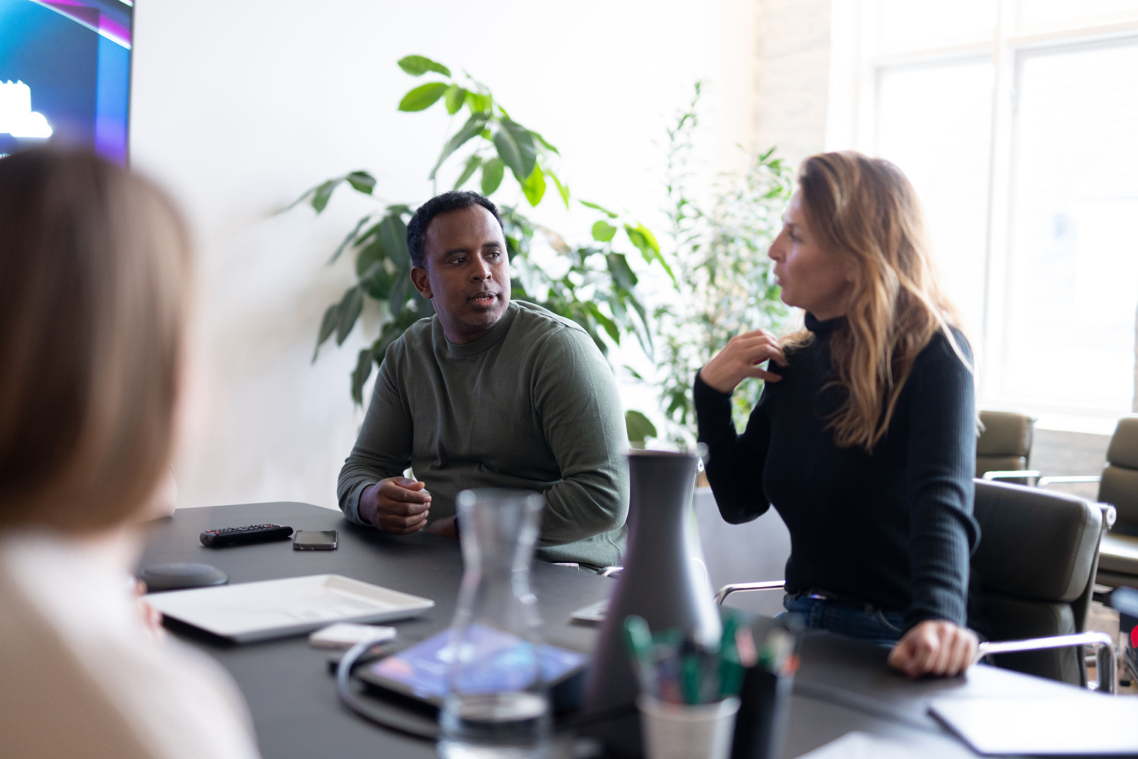 Munu colleagues talking around the meeting table
